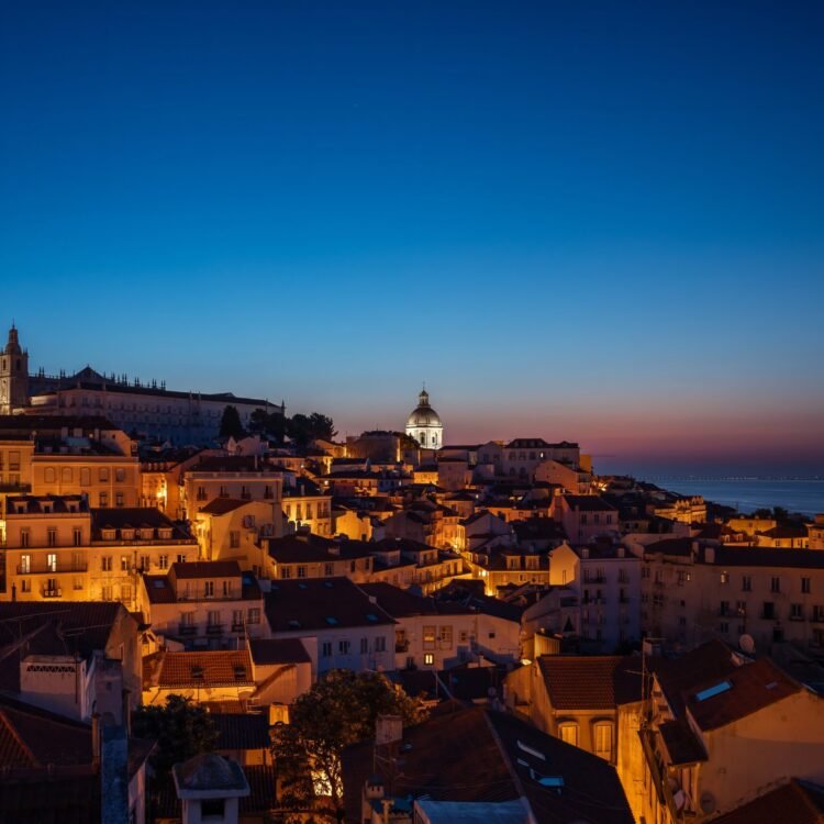 Sunset view of Alfama, Lisbon rooftops with dome and coastline – fine art photography print