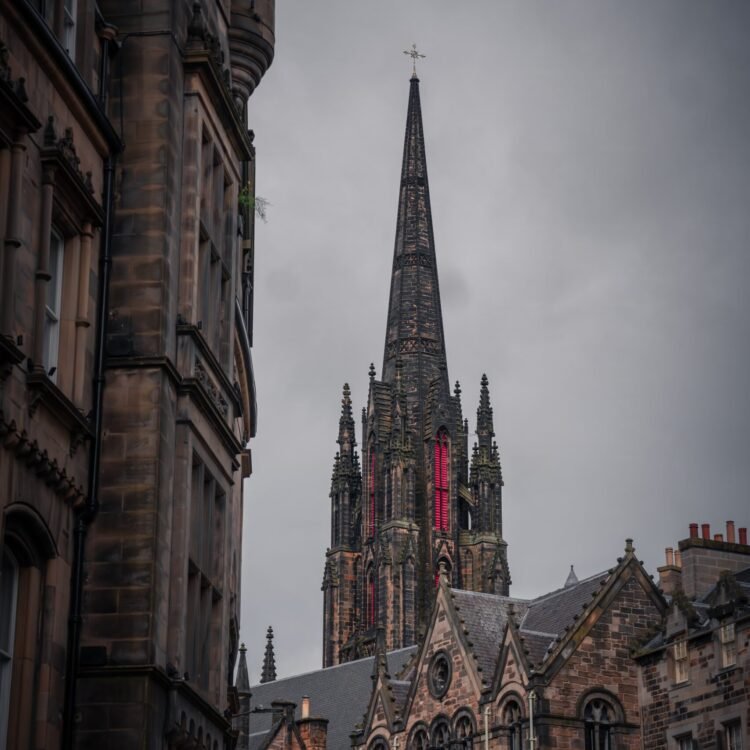 Gothic church spire at Castlehill, Edinburgh framed by historic buildings – fine art photography print