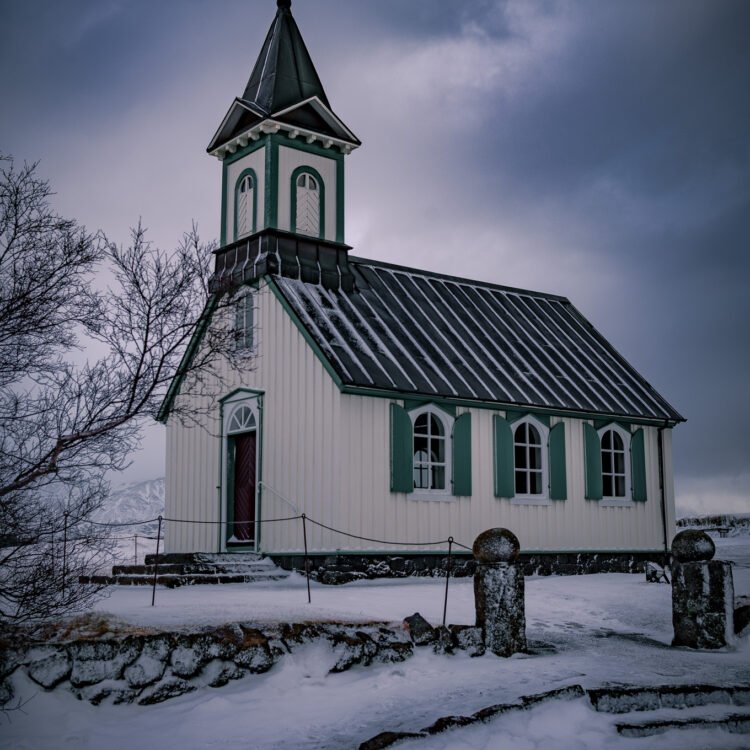 Winter photo of Thingvellir Church in Iceland with snow and dramatic sky – fine art print