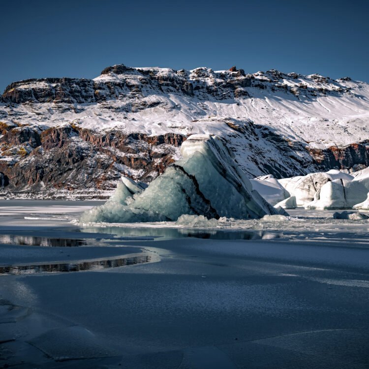 Frozen Reverie – Iceland glacier print with floating blue ice and snowy mountain backdrop